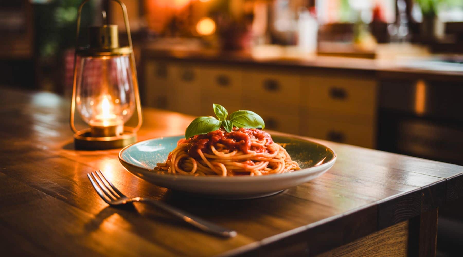 Plate of spaghetti with tomato sauce on a kitchen table